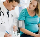 Pregnant woman talking to doctor