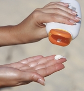 Woman holding sunscreen bottle